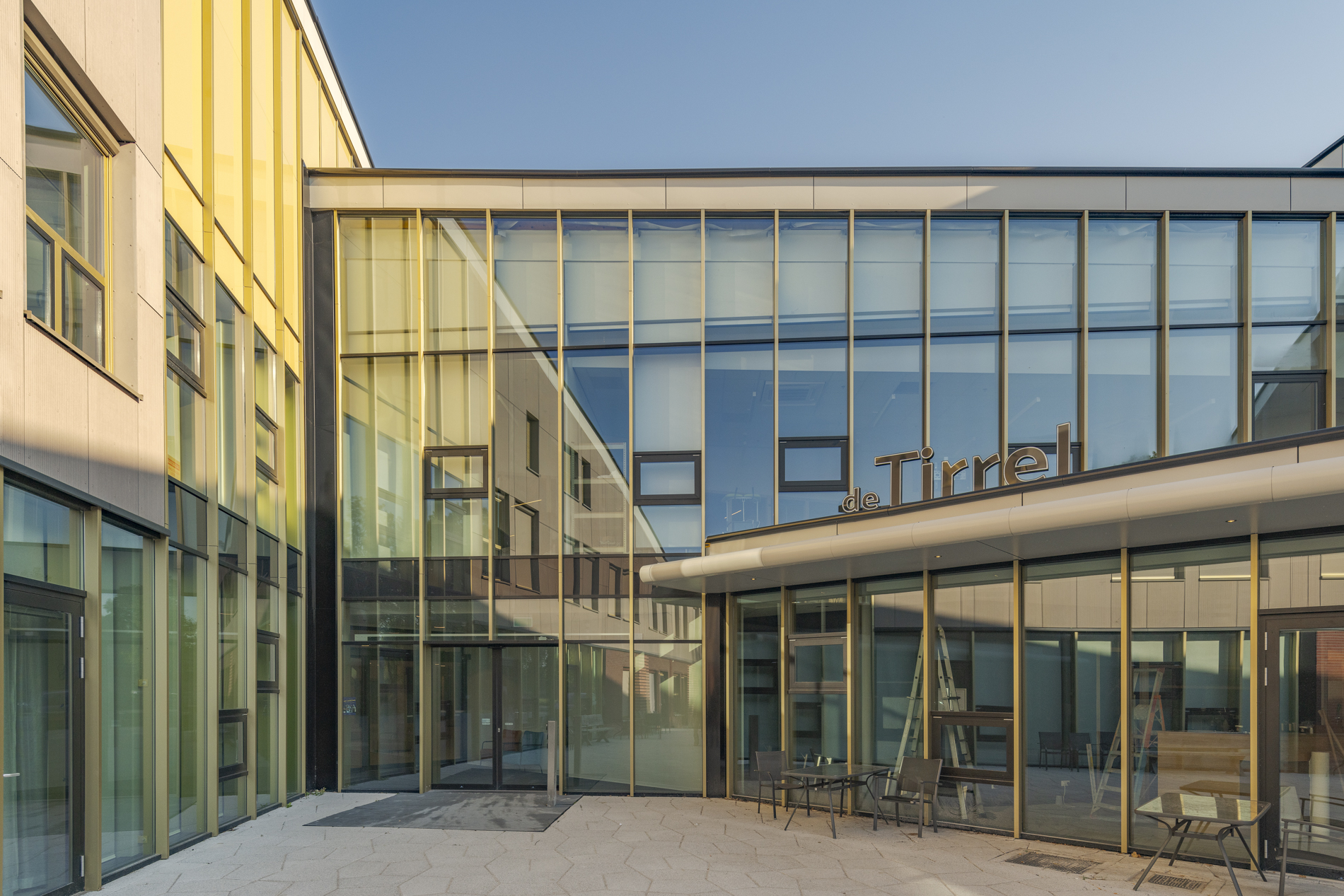 Zijaanzicht van De Tirrel in Winsum met moderne lijnen en glazen gevel.